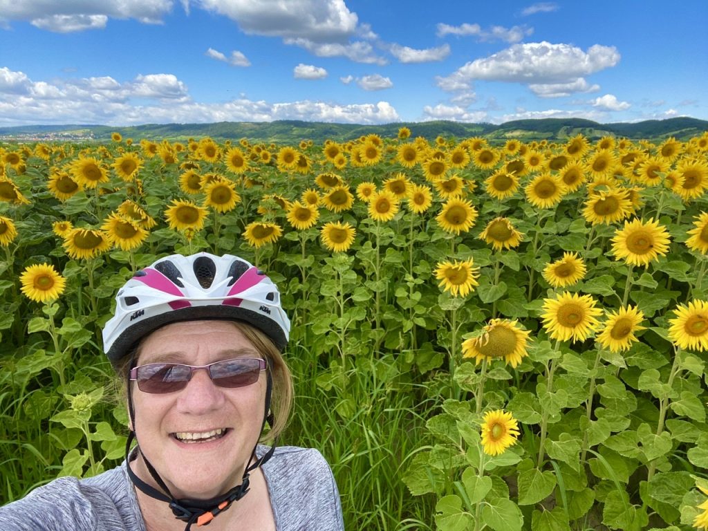 Lindsey from E-Bike Europe in front of sunflowers in Burgenland
